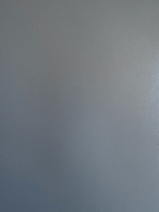 Plain blue-gray textured surface with subtle speckled finish (no focal objects).