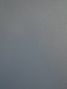 Close-up of a blue-gray painted wall with subtle horizontal brush strokes and texture.