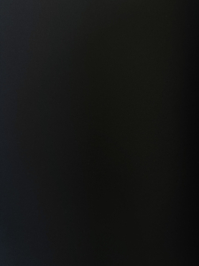 Solid black textured background with a subtle grainy surface