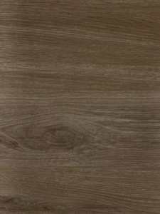 A close-up of a brown wood grain surface with visible knots and texture.